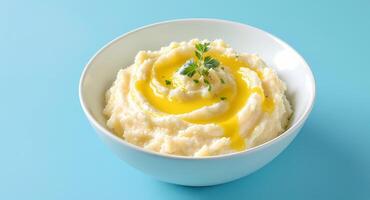 Mashed Potatoes with Gravy and Parsley in White Bowl on Blue Background photo