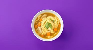 Noodle Soup Bowl with Carrots and Parsley on Purple Background photo