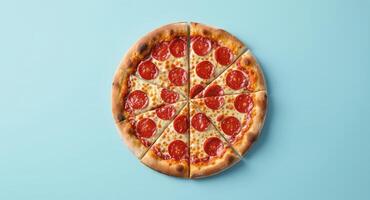 Pepperoni Pizza Slices on Light Blue Background Top View photo