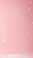 White confetti falling on a pink background for a festive celebration photo