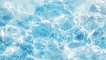 Clear blue ocean surface reflecting sunlight with gentle waves and bubbles photo