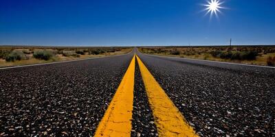 Asphalt Road Cutting Through Desert Under Bright Sun photo