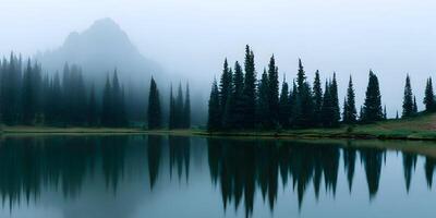 a mountain and trees are reflected in a lake photo