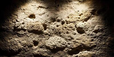 Rough Beige Stone Wall Texture Background Illuminated Spots photo
