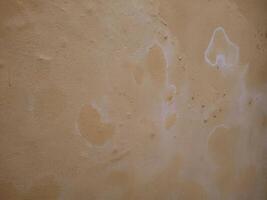 a wall with white paint on it and some stains photo