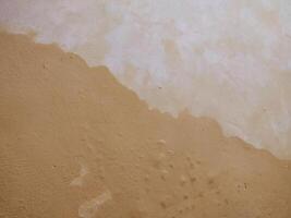 texture rough and uneven yellow wall background, creating a lively and abstract background. photo