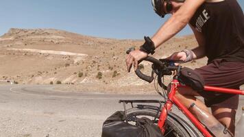 Cyclist checking offline maps navigation on smartphone attached to red bicycle while touring, concept of route planning, decision-making, resilience, solitude, freedom, exploring unknown landscapes video