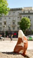 Vertical time lapse Ice cream melts rapidly under intense sun heat during summer morning in city. Symbolic visual metaphor global warming, rising temperatures, urban heat islands, public health danger video