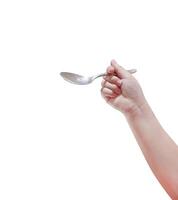 Spoon in child's hand, isolated on white background. photo