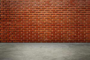 An empty room with red brick walls. The red brick walls are lit with warm lighting. photo
