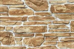 Decorative light brown stone masonry background photo