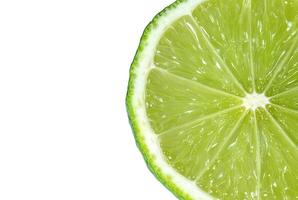 Juicy slice of lime citrus closeup on the white background photo