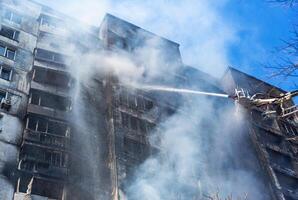Extinguishing a fire in a multi-storey building after shelling by the Russian army photo