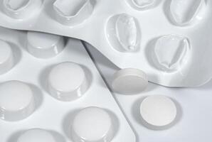 Blister pack with pills and used blister without tablets close up photo