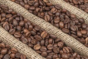 Coffee beans on burlap fabric with folds photo