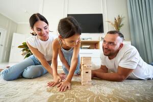 Family enjoys a fun jenga game at home on a sunny afternoon photo