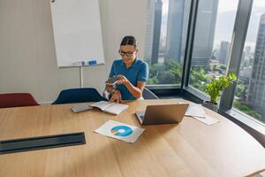 A Professional Woman is Actively Engaged in a Modern Office Setting and Work Environment photo