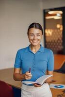 A Smiling Professional Woman Working in a Bright and Modern Workspace Environment Setup photo
