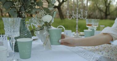 An Elegant Outdoor Table Setting Enhanced with Beautiful Floral Decor and Refreshing Beverages video