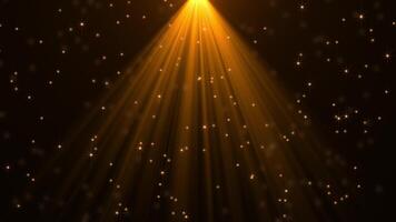 Abstract golden particles animation concept for birthday and holiday celebration with bright rays from spotlight. 4k bokeh effect background with light particles and stars rising on dark background video