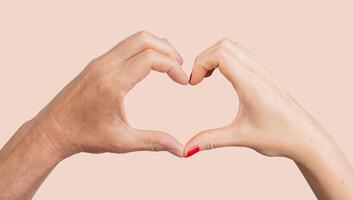 Hands forming a heart, symbolizing love, warmth, and togetherness. Affectionate gesture representing photo