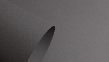 Gray matte paper with a textured surface, featuring wavy folds and perforated edges. Elegant, modern photo
