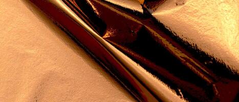 Elegant bronze foil texture with a glossy, holographic finish. Wrinkled, creased folds creating a photo