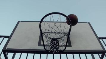 Basketball flies straight towards basket, but it hits backboard and bounces off. It is an unfortunate mistake by the streetball team. Slow motion. below video