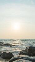 A man standing on a rock at the beach video