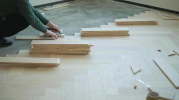 Worker installing wooden flooring with hammer and tapping block 10 video