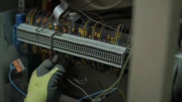 Electrician working on circuit breakers inside control panel 9 video