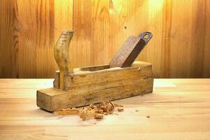 Vintage Wooden Plane Tool on Rustic Wooden Workbench photo