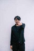 Enthusiastic young man extending his fist with a motivational gesture photo