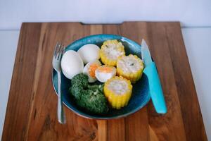 Bright overhead view of healthy food on wood cutting board table photo