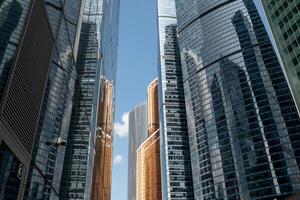 Modern Architecture Reflects Sunlight in Moscows Vibrant Cityscape Showcasing Towering Skyscrapers During a Clear Day photo
