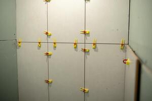 Drywall Installation Process in a Home Interior With Colorful Clips Used for Securing Panels During Alignment and Setup photo