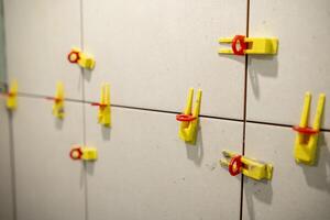 Tools and Materials Used for Tile Installation Displayed on a Wall in a Construction Site During the Day photo