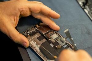 Expert Phone Repair in Progress With Detailed Attention to Internal Components at a Workshop photo