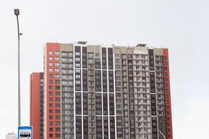 Modern Residential Building Under Construction With Scaffolding and Workers Visible During Daylight photo