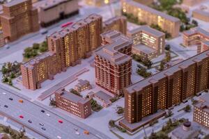 Detailed Architectural Model Showcasing a Modern Urban Development Project at Night With Illuminated Buildings in a City Setting photo