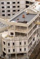 New Commercial Building Under Construction With Modern Architecture Details and Ongoing Worksite Activity in a Bustling Urban Area photo