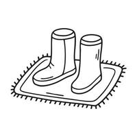 Ugg boots left on a welcome mat by the door vector