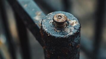 Detailed View of a Corroded Screw Resting on an Old Railing photo
