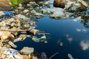 Lake covered with floating garbage and plastic waste. Environment pollution photo