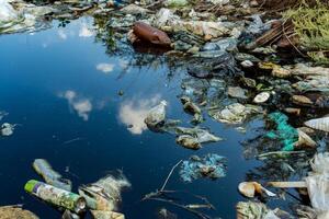 River or lake covered with floating garbage and plastic waste. Pollution from garbage causes water to become polluted. Environment pollution photo
