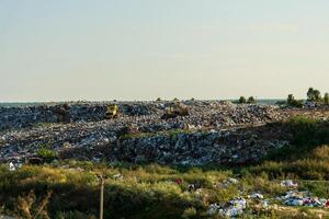 A large accumulation of garbage. Trash piles in landfill. Environment pollution photo
