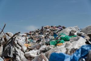 A large open-air garbage dump. Close-up of plastic waste at the landfill. Pollution of the planet with garbage photo