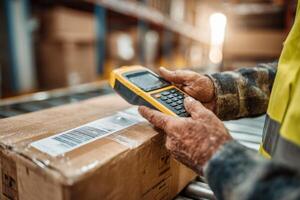 A person in a safety vest holding a handheld device photo