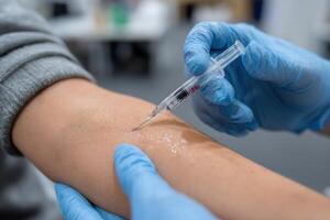 A person getting an injection from a needle photo