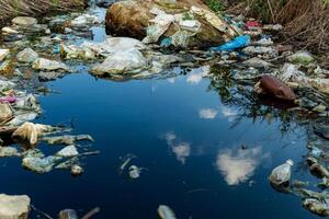 Trash and plastic bottles in water. Garbage and pollution on water. Environment pollution photo